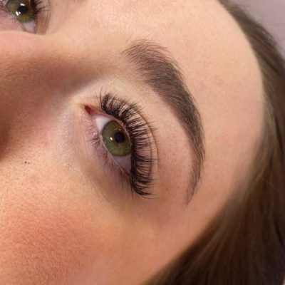 brown eyed female having hybrid eye lashes applied in a beauty salon